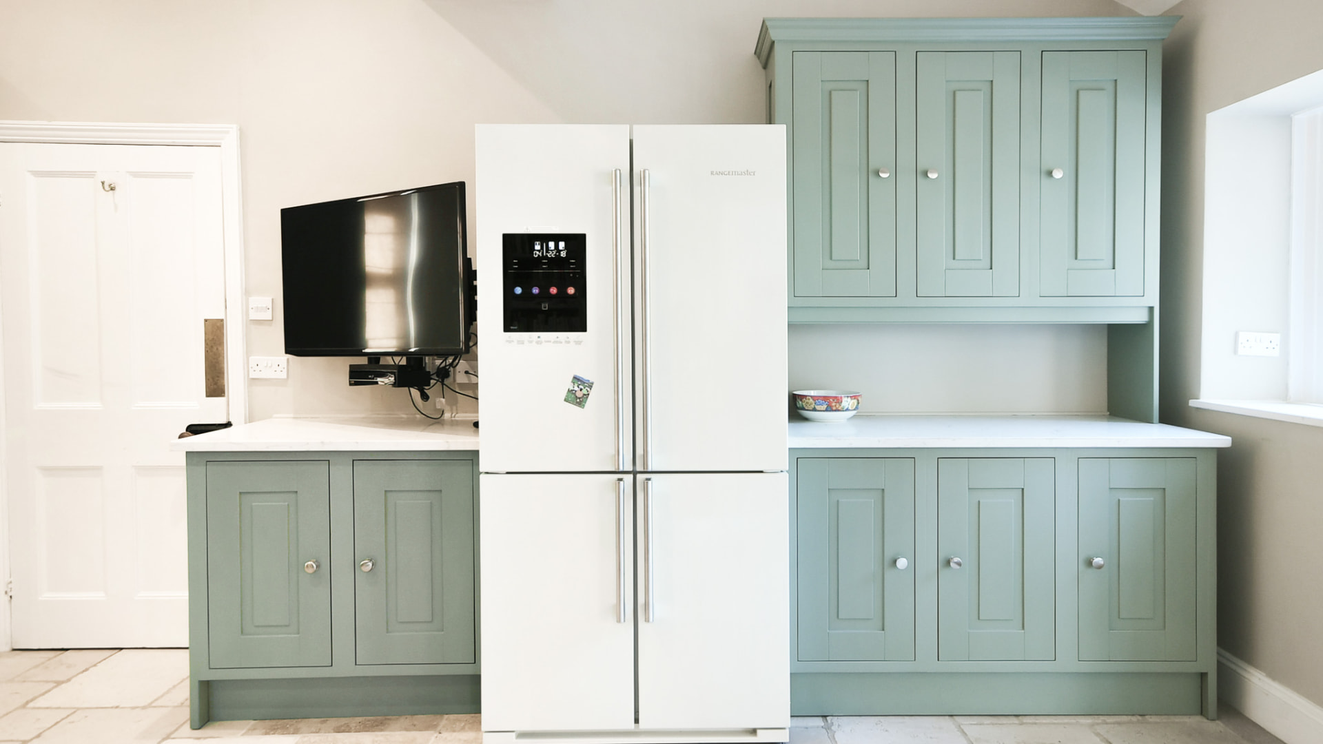 Finished green dresser and matching base cabinetry beside the fridge in the Malmesbury kitchen