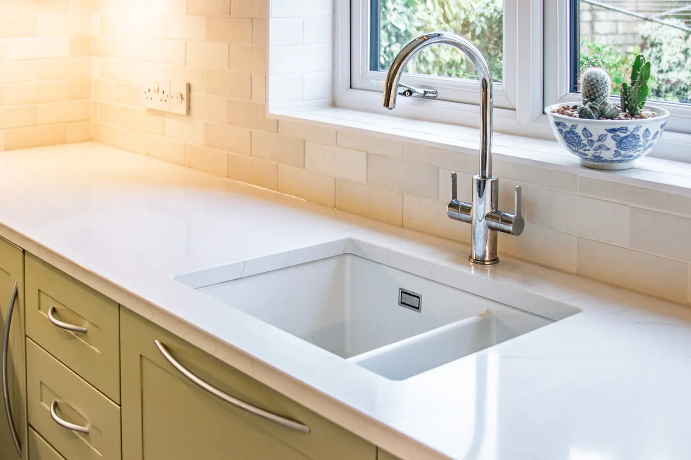 Undermount ceramic sink and chrome tap in a new white quartz worktop