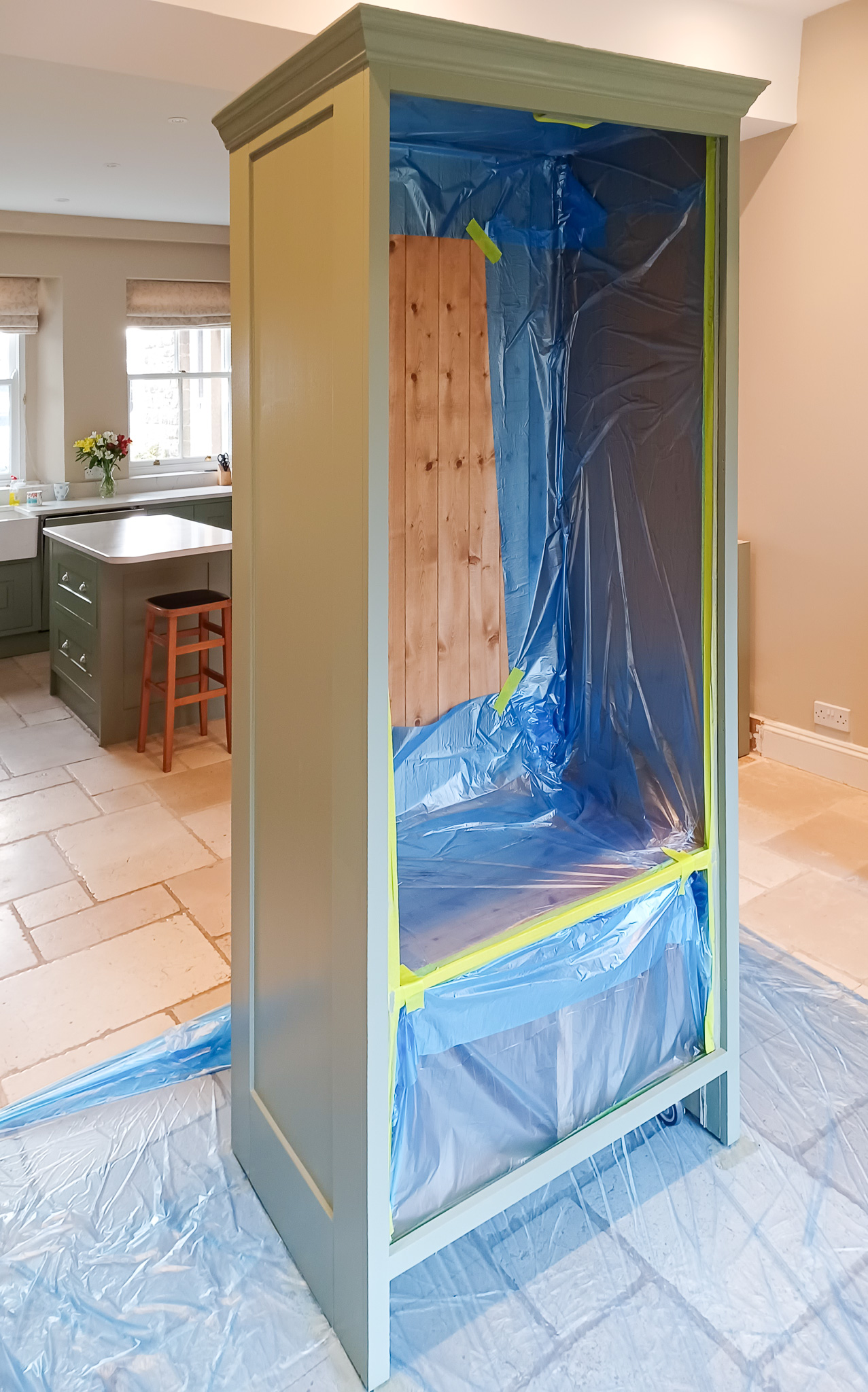 Hand-painted cabinet in Malmesbury, with its unfinished pine interior lightly masked off.