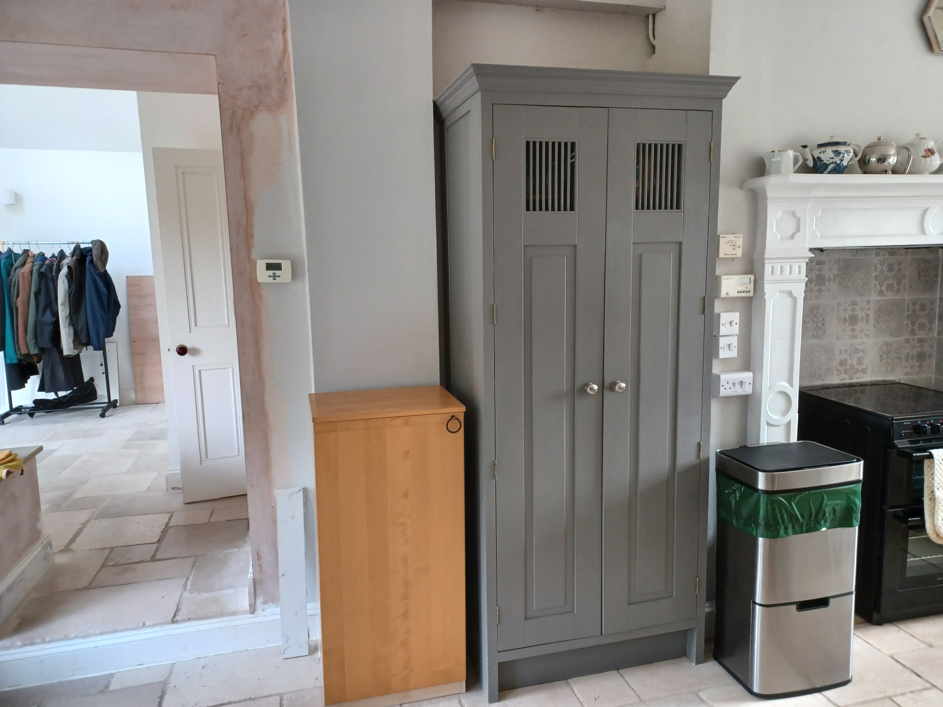 Tall cupboard beside the range cooker alcove and a stub wall in the Malmesbury kitchen before work