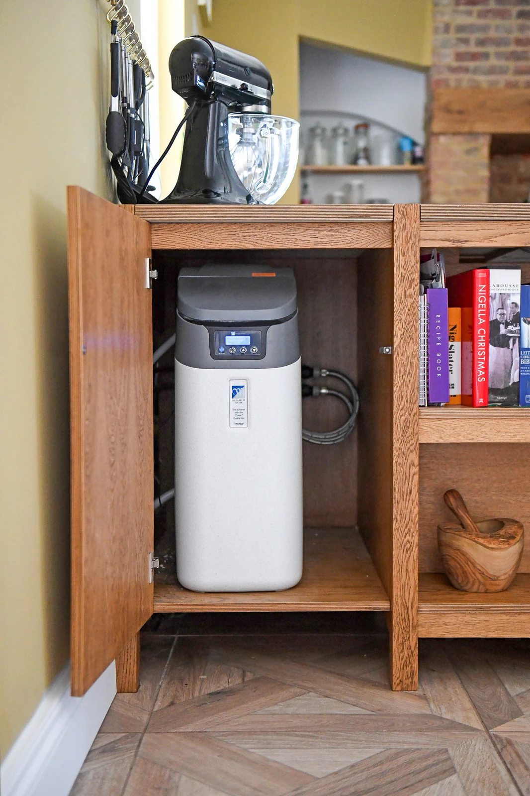 Water softener tucked inside an oak cupboard in the Melksham bespoke kitchen
