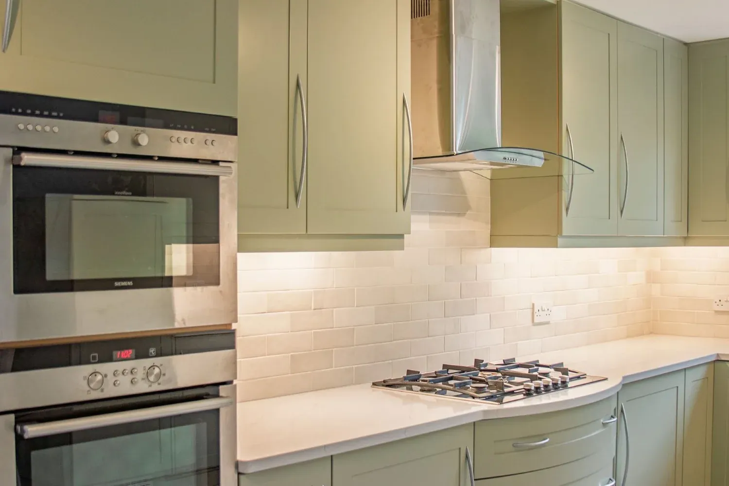 The same kitchen after replacement doors, new worktops, sink and tap