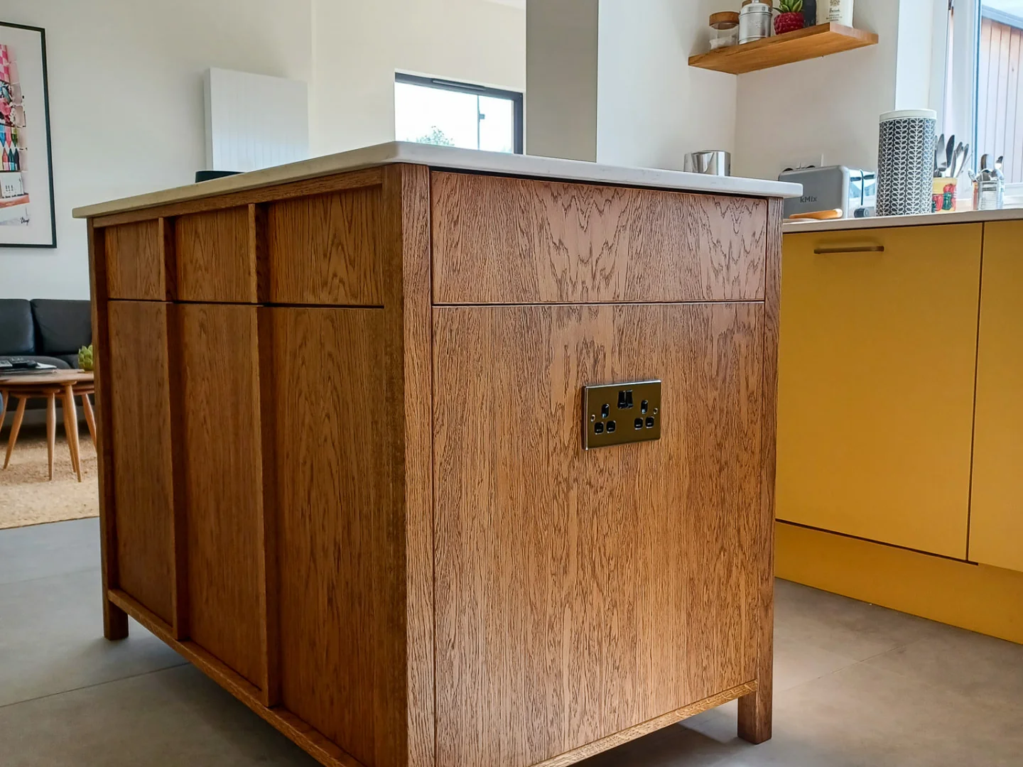 Bespoke oak kitchen island with framed timber panels and a white worktop