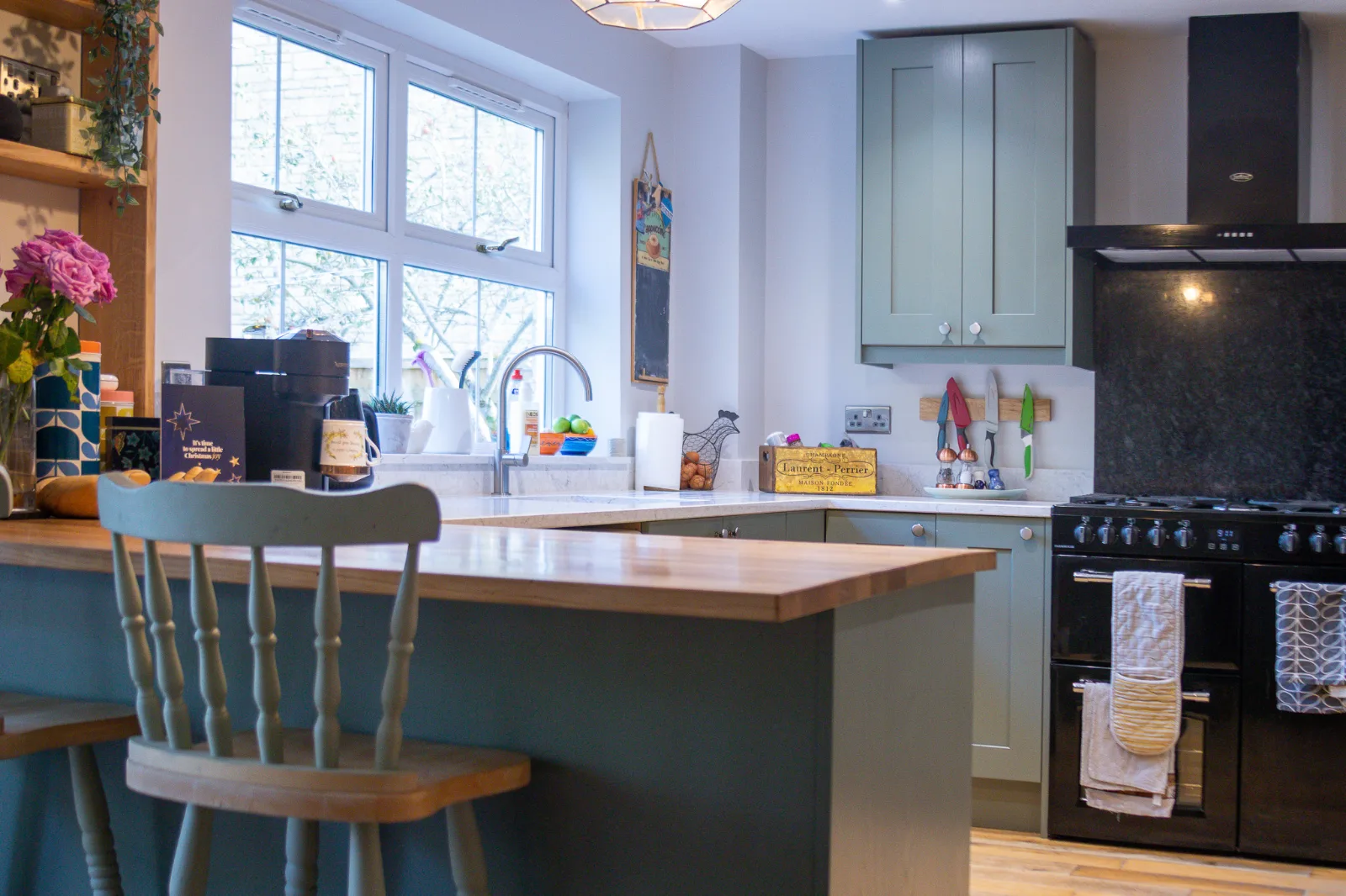 A newly installed custom kitchen with high quality cabinets and a solid oak peninsula in a Wiltshire home.