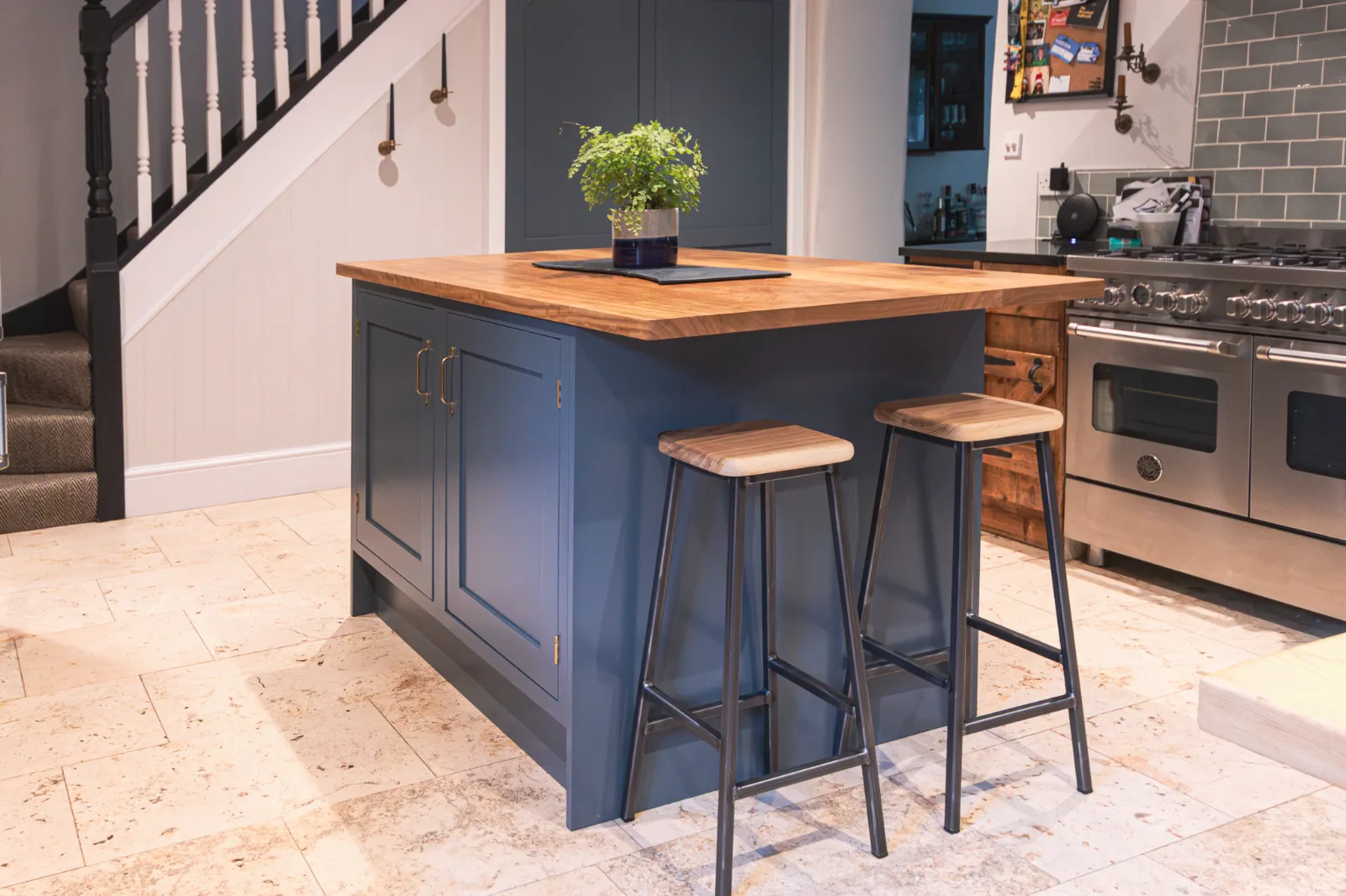 A bespoke kitchen island by Nick Archibold with integrated seating and custom storage in a Wiltshire home.