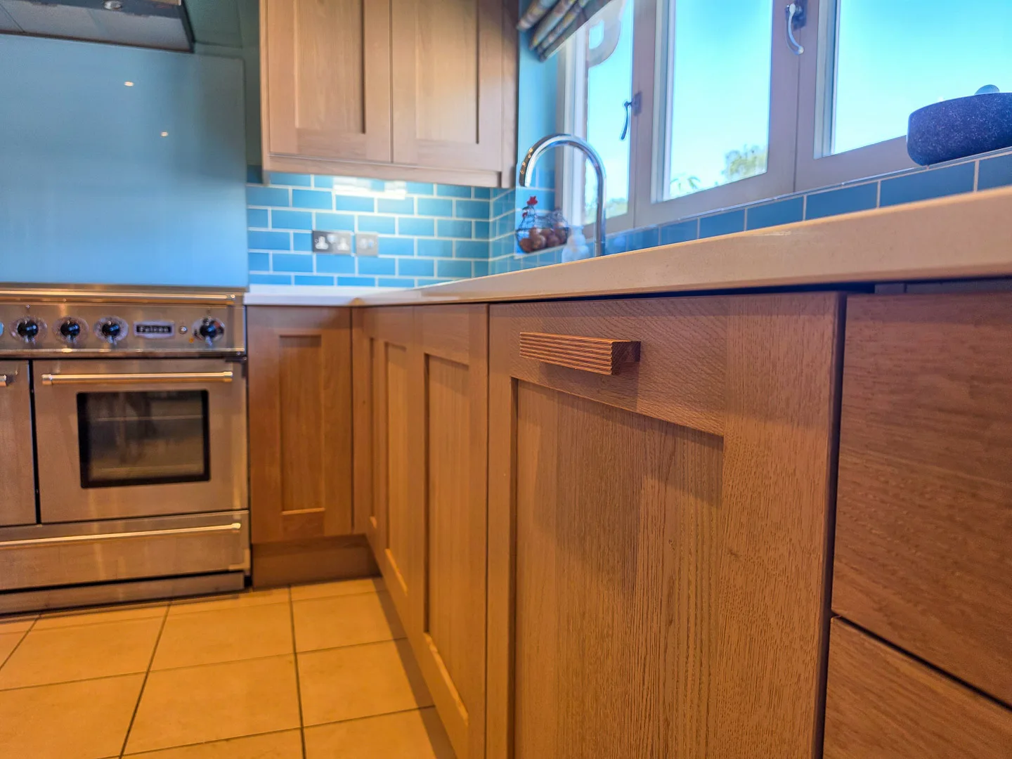 A refreshed kitchen with new replacement solid oak doors and quartz worktops looks like new.