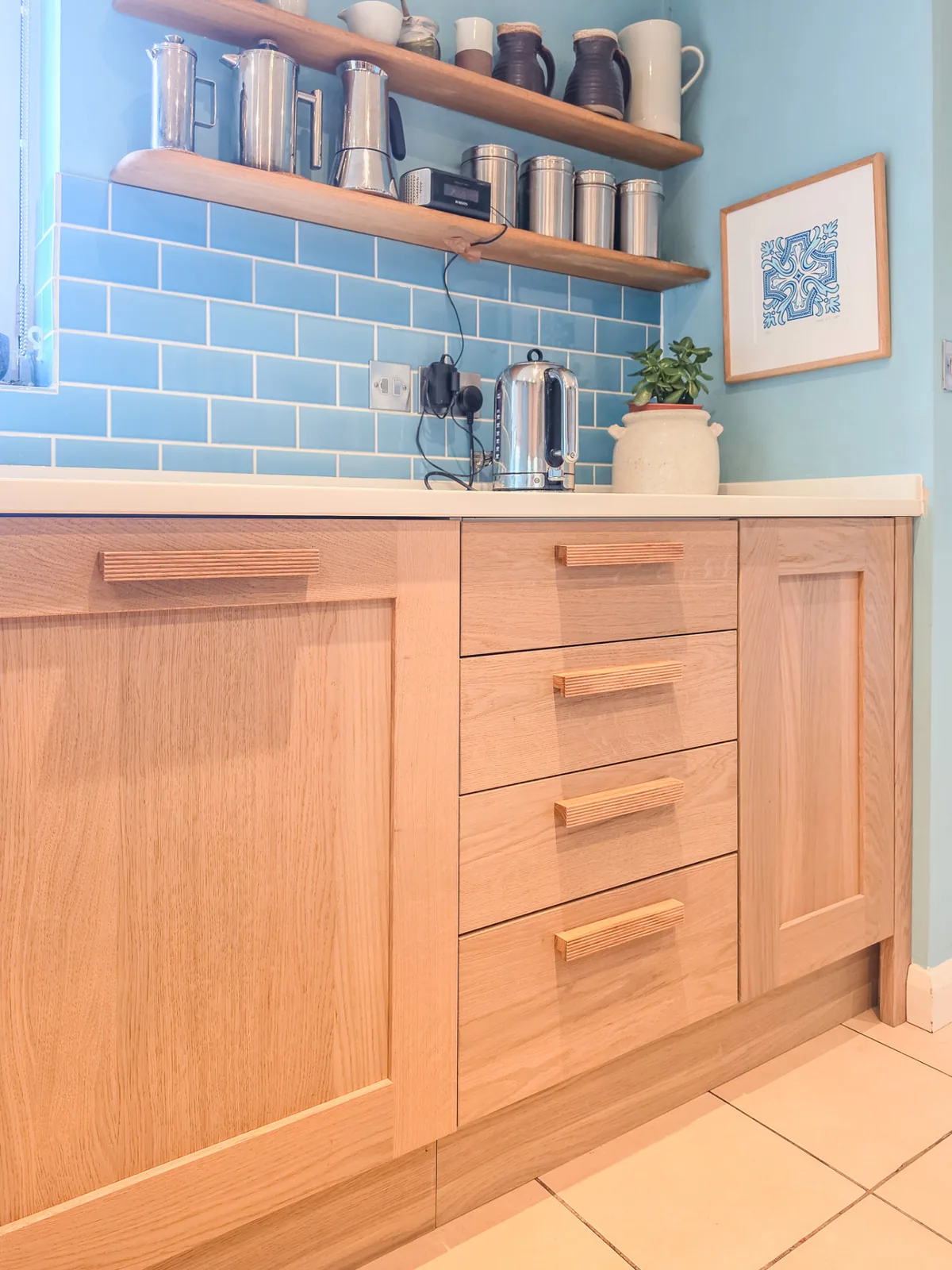 New oak drawer fronts and handles beneath open oak shelves