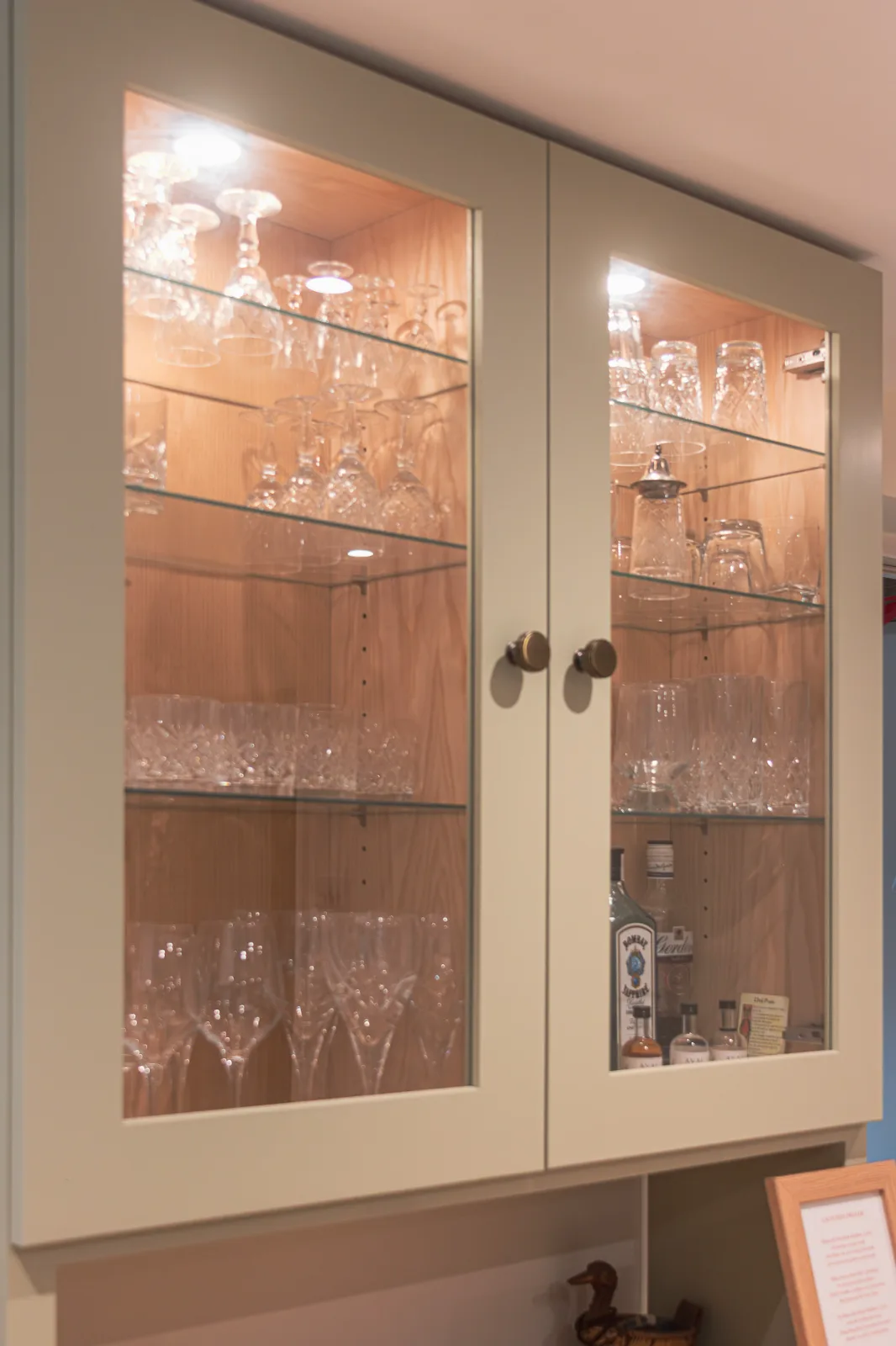 Glazed doors, adjustable shelves and LED spotlights