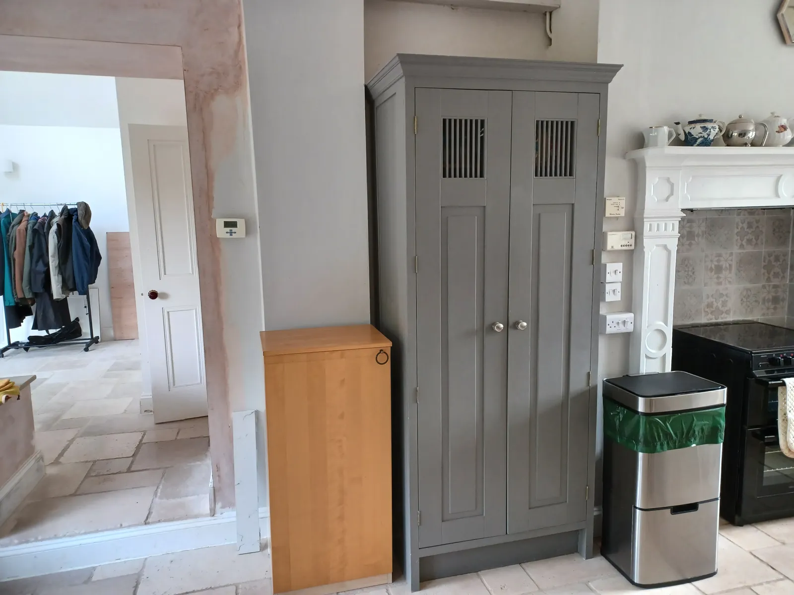 The tall grey larder cupboard before the bookcase was added